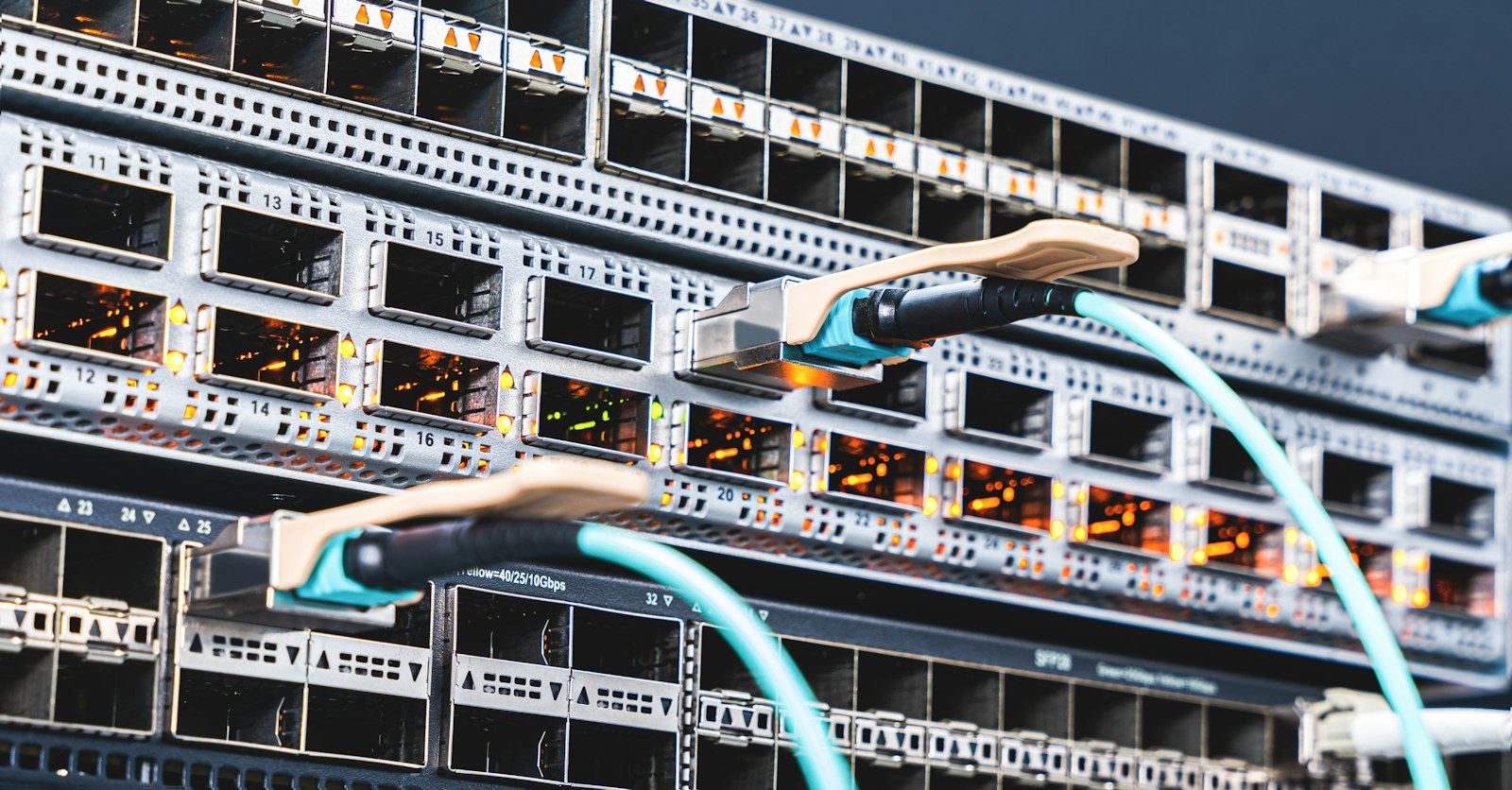 Network switch ports with fiber cables in a data center, representing IPv4 to IPv6 address infrastructure
