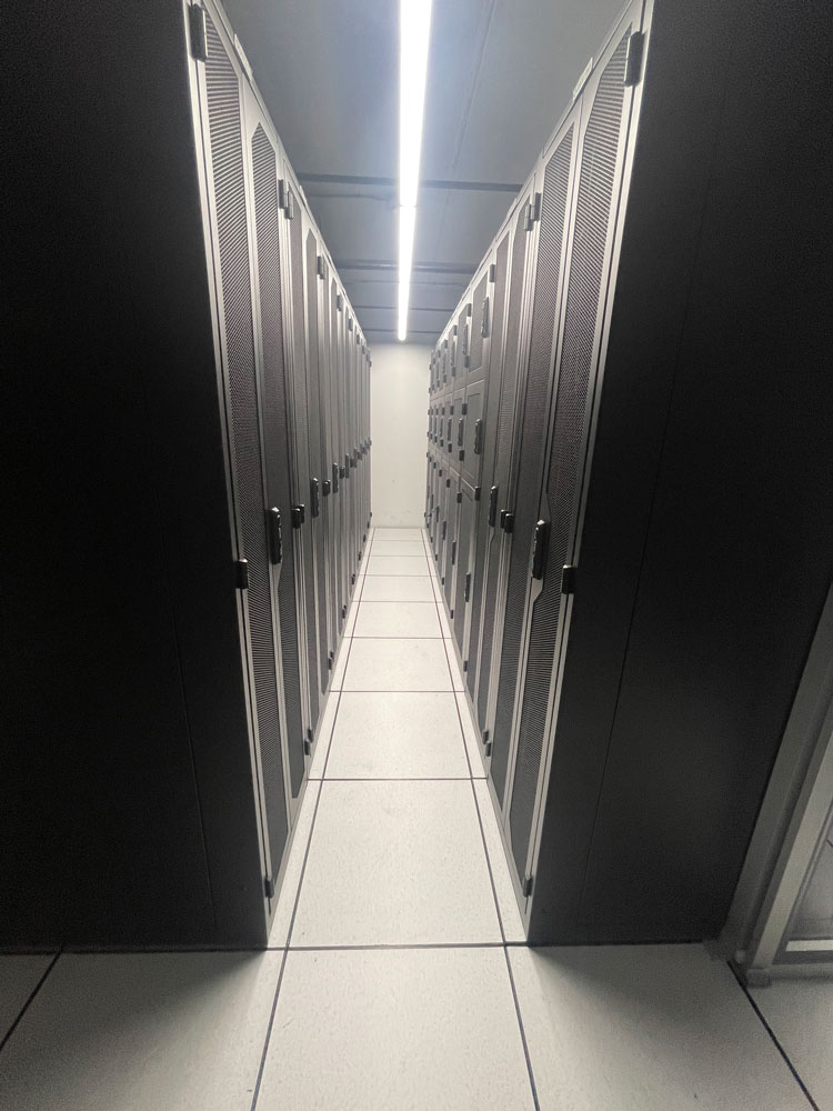 Aisle of locked server cabinets inside Volico's Deerfield Beach colocation data center