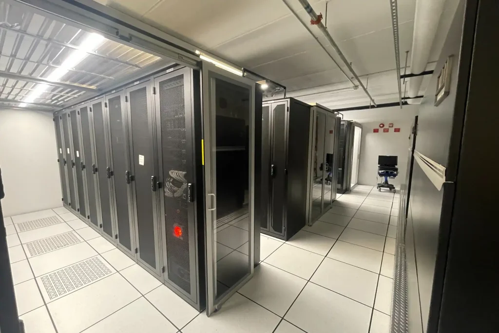Cold aisle lined with locked colocation server cabinets